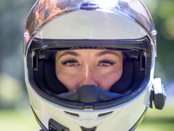 Close up head shot of young female in a full face motorcycle helmet