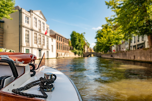 Boat trip on a canal in Bruges with boats hull in shot