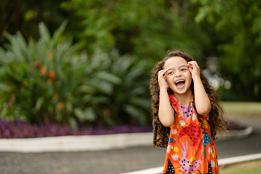 Portrait of little girl smiling in nature
