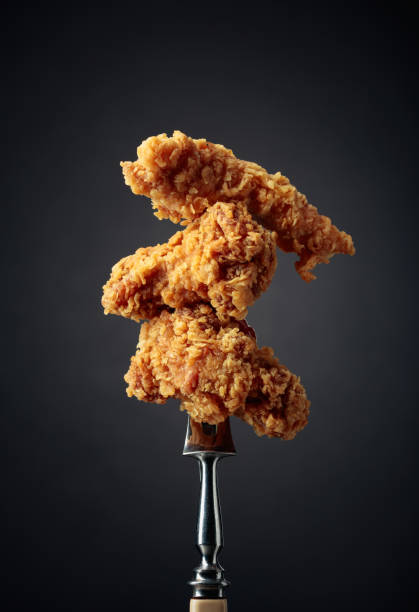 Fried chicken on a fork. stock photo