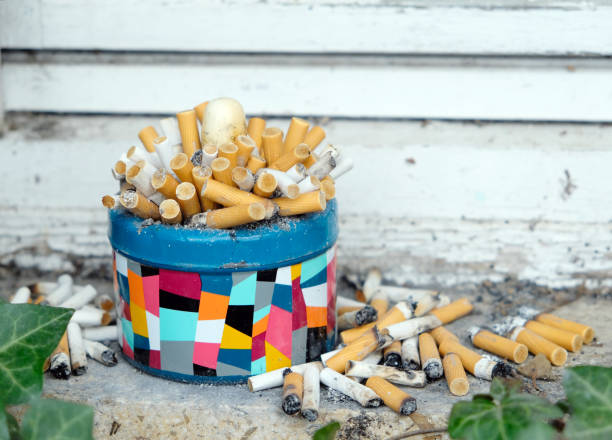 istock Colorful ashtray overflowing with cigarette ends 1409921238
