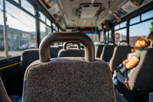 Single mother with children on the way to work in the morning on an empty bus. High quality photo