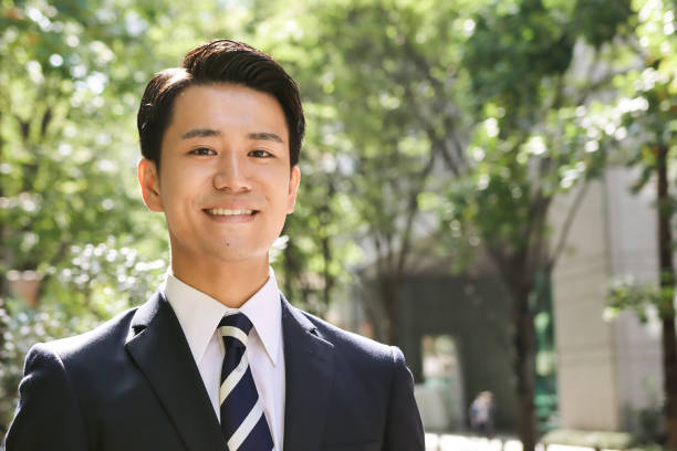 Portrait Of A Young Asian Businessman With Smile At Outdoors stock photo
