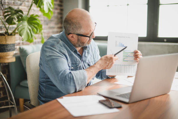 istock Mature adult man working from office 1409927744