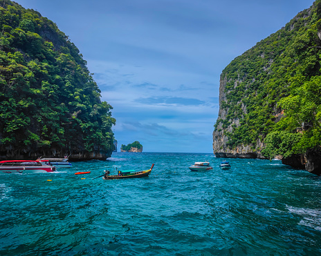 Many boats standing in turquoise water lagoon in Phi Phi Leh island bay in Thailand