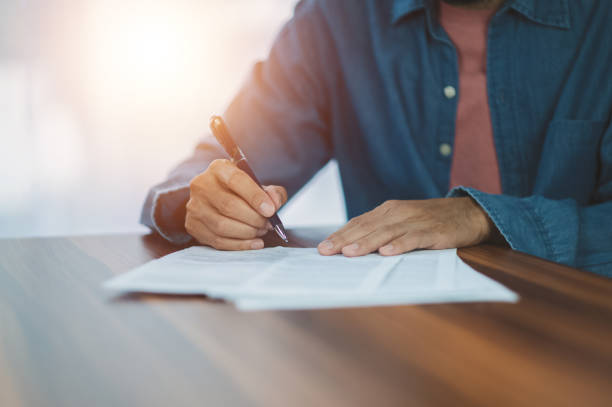 istock Closeup hand sign on document,  signature contract executive 1409929530