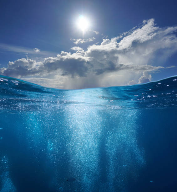 istock Seascape air bubbles underwater sea and sunny blue sky with cloud 1409930946