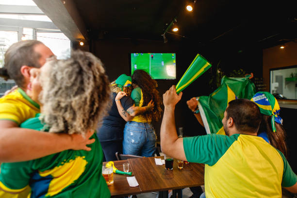 group of Brazilian friends, celebrating a Brazilian goal. group of brazilian friends watching game at a bar international soccer event photos stock pictures, royalty-free photos & images