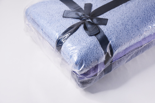 Gift package of towels with ribbon on the white background
