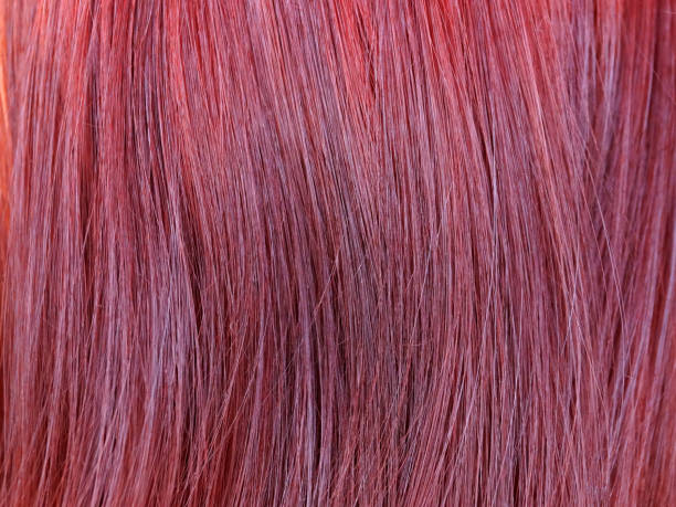 istock dyed red female hair closeup, texture for background 1409935017
