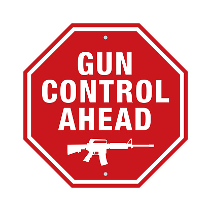 A red stop sign with the words GUN CONTROL AHEAD and an assault rifle message illustration.