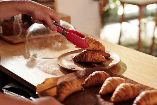 istock Barista Putting Hot Croissants on Plate 1409940054