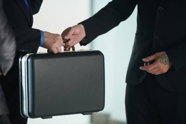 istock Businessman Giving Briefcase with Product 1409941539