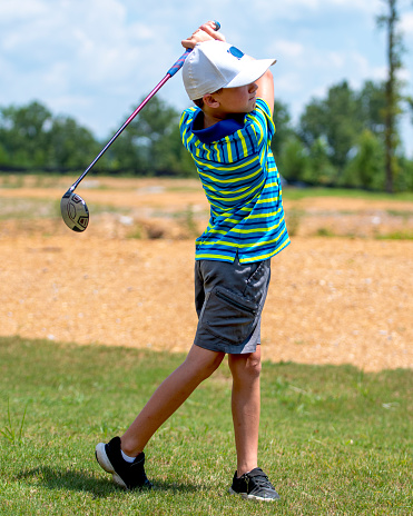 Boy Swinging a Golf Club