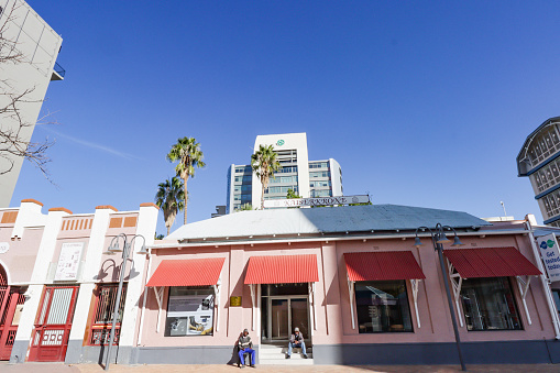 Kaiserkrone on Post Street in Windhoek, Namibia. These is a shopping area featuring German colonial architecture, with incidental people outside.