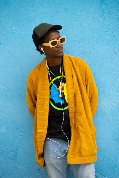 istock Casual African guy looking away with hands behind his back 1409948365