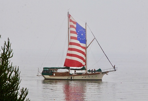 Decorated ship with patriotic sail at a 4th of July water parade