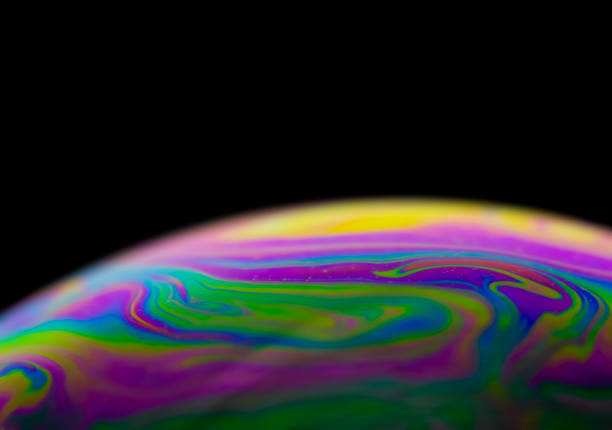 istock Colorful stripes on soap bubble with black background and selective focus. 1409949272