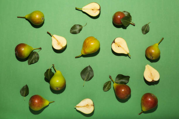 istock Fresh pears on green background, flat lay composition, top view space 1409951514