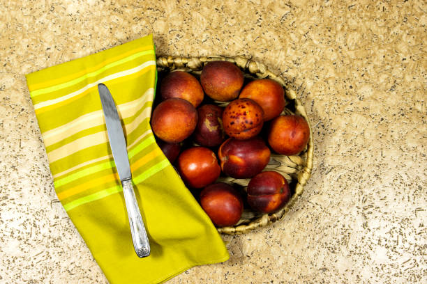 Ripe peaches on a white plate. Juicy fruits.