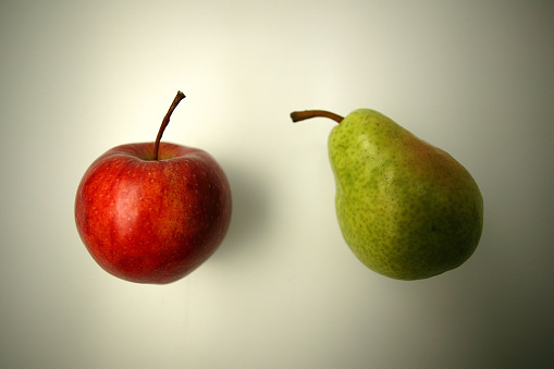 concept  of comparison green apple vs. red apple isolated on white background