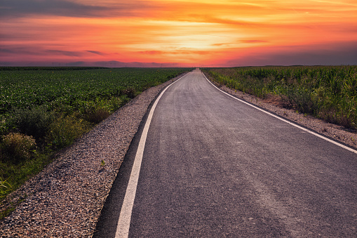 Empty asphalt road at the sunset