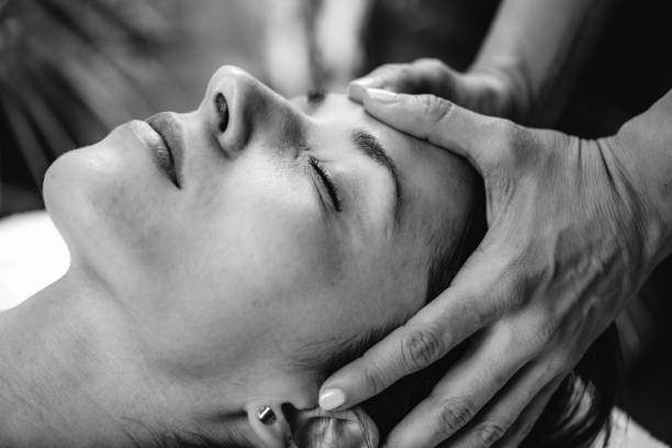 CST therapist Massaging Woman’s Head. Craniosacral Therapy Massage. stock photo
