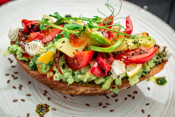 istock Bruschetta with sun-dried tomatoes, cream cheese, avocado and fresh vegetables. 1409954418