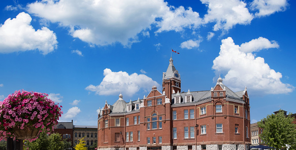 Red brick city hall with a clock tower in the scenic historic center in Stratford, Ontario.