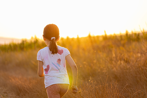 Photo of vitality girl running through field stock photo