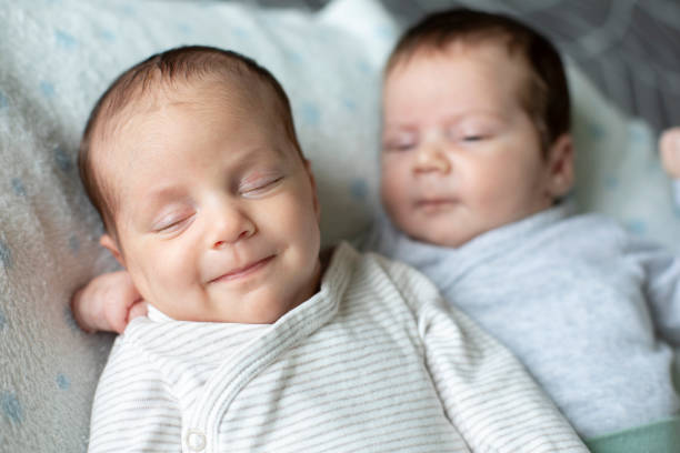 istock Cute Fraternal Twin Babies, Brother and Sister, lying on their back 1409957690