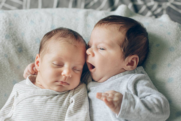 istock Cute Fraternal Twin Babies, Brother and Sister, lying on their back 1409957717