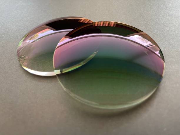 istock Two green gradient sun protection plastic eyeglass lens on Black - white background. 1409958053