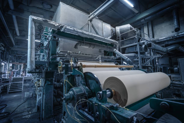 Paper production machine in wastepaper recycling factory. Paper and pulp mill. stock photo