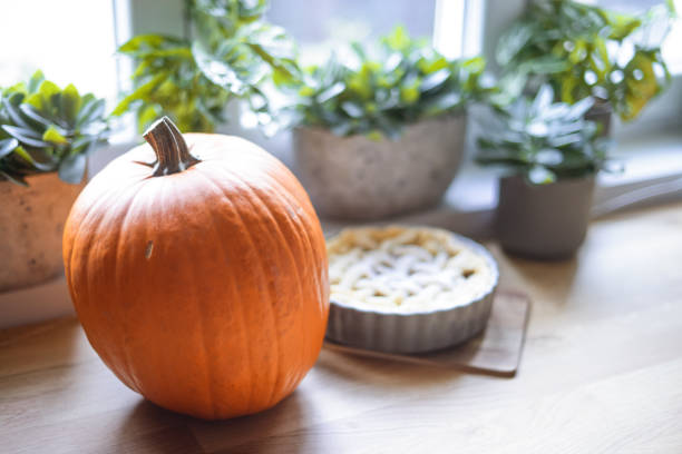 ripe pumpkin lies on the table in the kitchen
