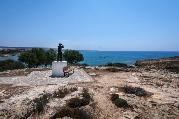 Ayia Napa, Cyprus - June 24, 2022:  Man with binoculars observer sculpture at the view point next to Vathia Gonia beach.