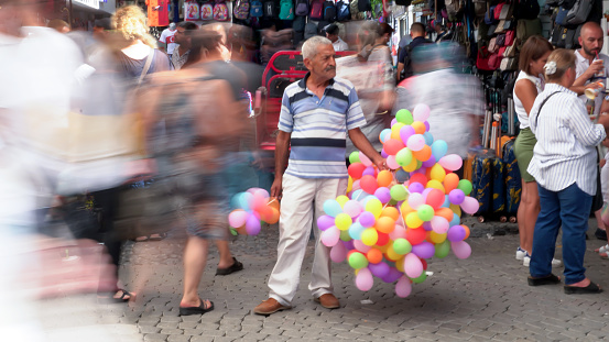 A street vendor sells colorful balloons in Kemeralti Bazaar,in Izmir, Turkey on July 19, 2022