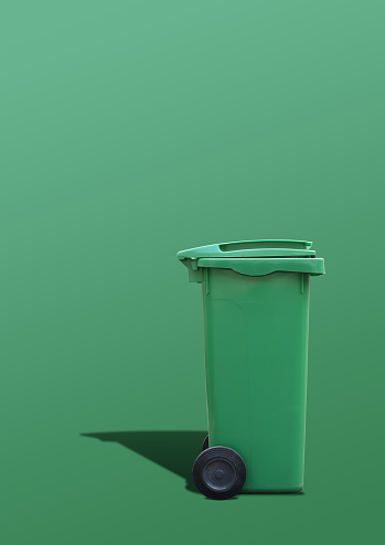 A green trash can tone on tone