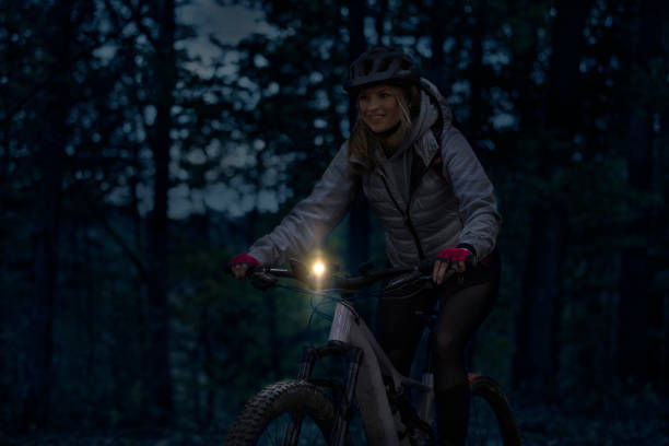 istock Young woman on a night e-bike ride 1409969549