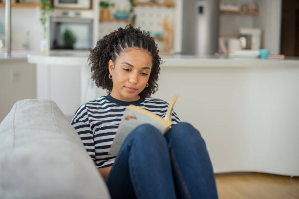 istock Woman relaxing and reading a book 1409969895