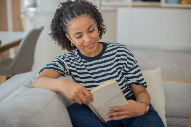 istock Woman relaxing and reading a book 1409969902