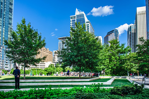 Charlotte, NC, USA. Jan 20,2020: A gathering of people protesting  at Romare Bearden Park, located in  the financial district of Uptown Charlotte,  North Carolina.