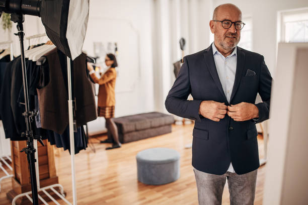 istock Man trying on suit in clothing store 1409978641