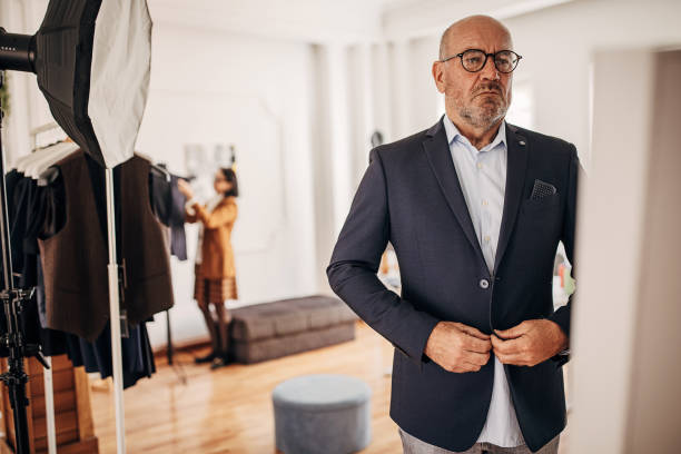 istock Man trying on suit in clothing store 1409978660