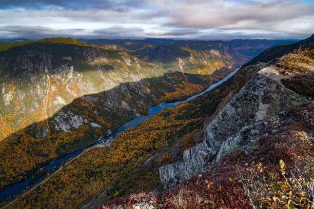 Vibrant colored foliage at the edge of the valley of Hautes-Gorges national park and Malbaie river, Quebec, Canada