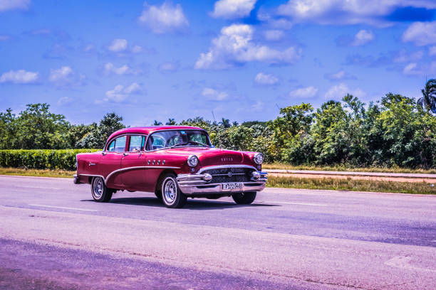 Old restored American car cruising the streets of Havana at night