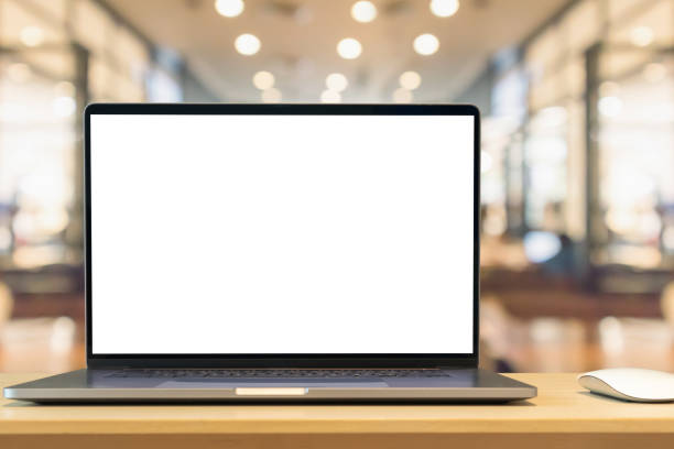 istock Laptop with blank screen on wood table with cafe coffee shop blur background 1409980351