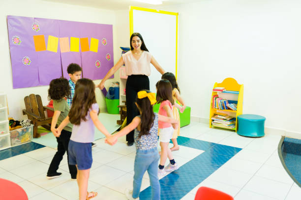 istock Teacher and kindergarten students playing a fun game at school 1409980688