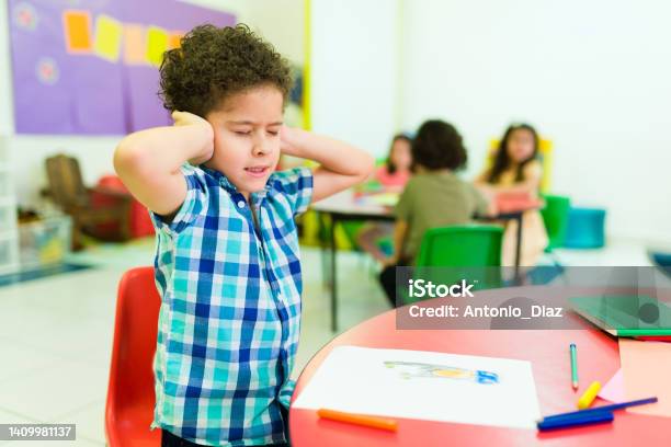 Overwhelmed Preschooler With Autism In Kindergarten Stock Photo - Download Image Now