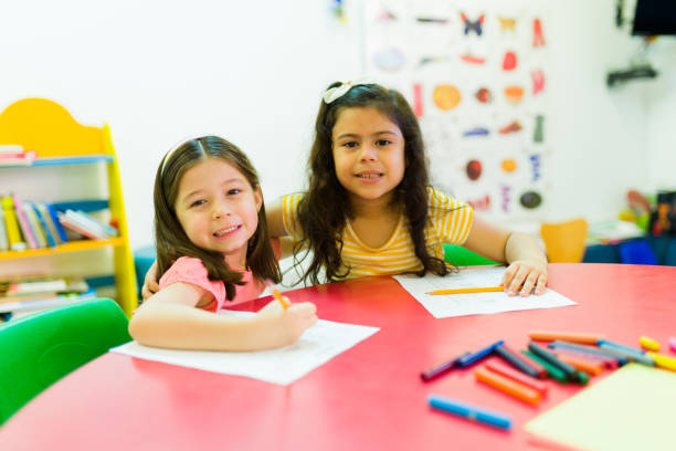 istock Mixed-race preschool friends doing school work together 1409981209